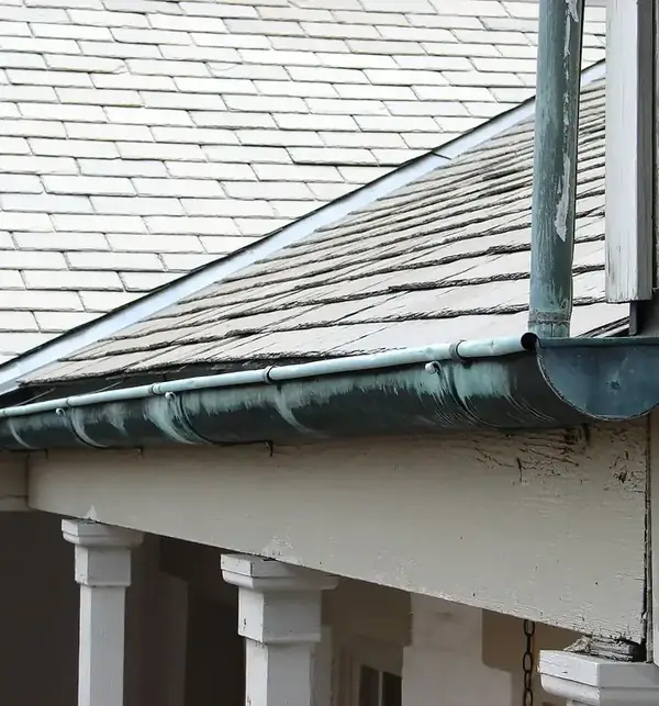 After: a clear gutter and downpipe carrying water away