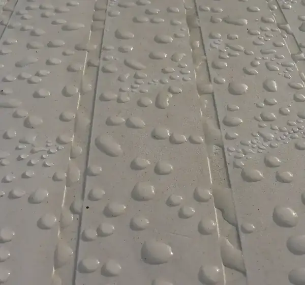 After: a sealed surface where rain beads and runs off