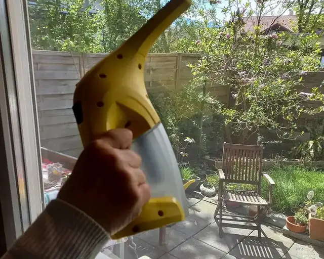 Cleaning a window with a squeegee vacuum